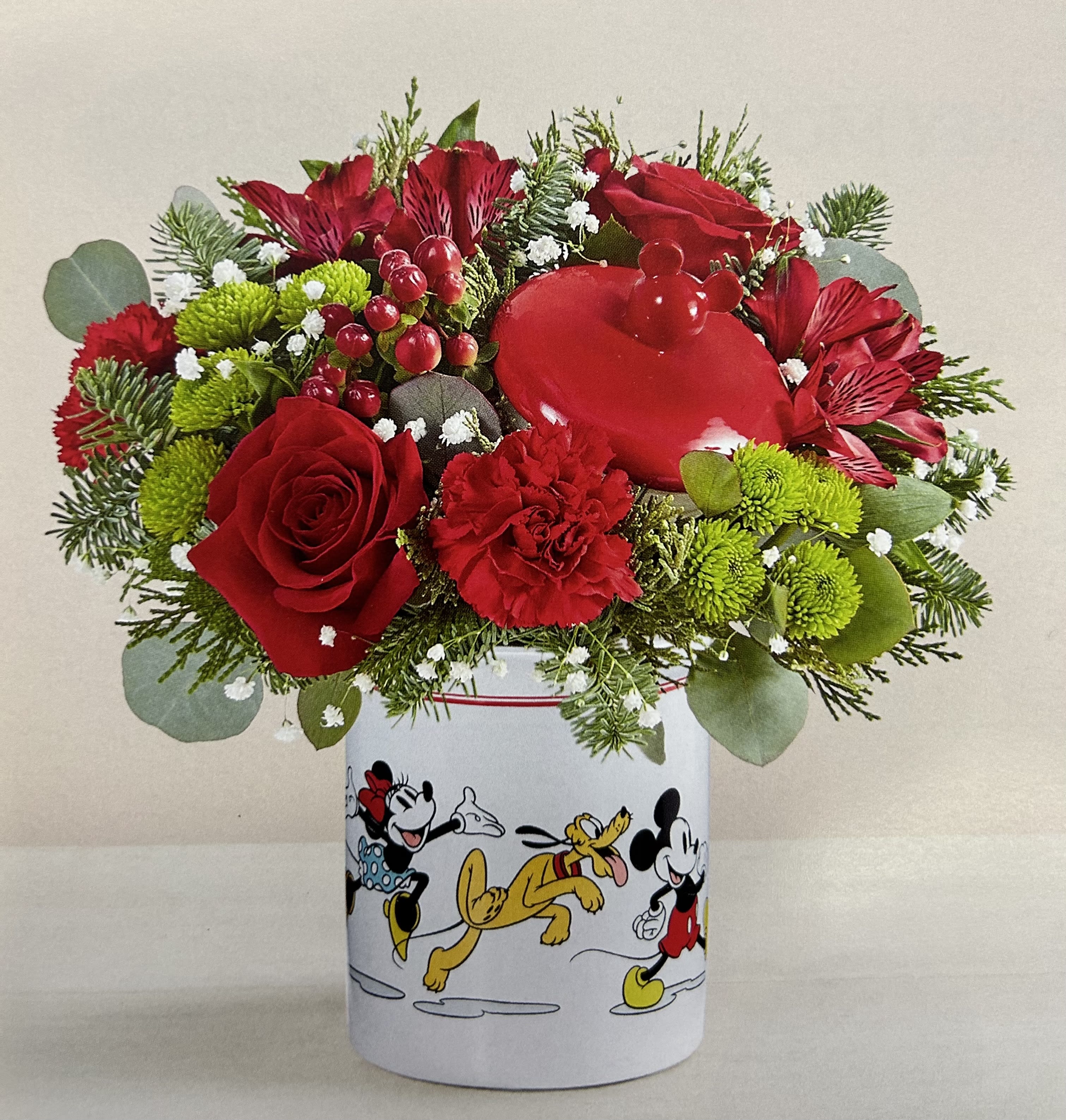 Red flowers arranged in a Mickey Mouse tin container