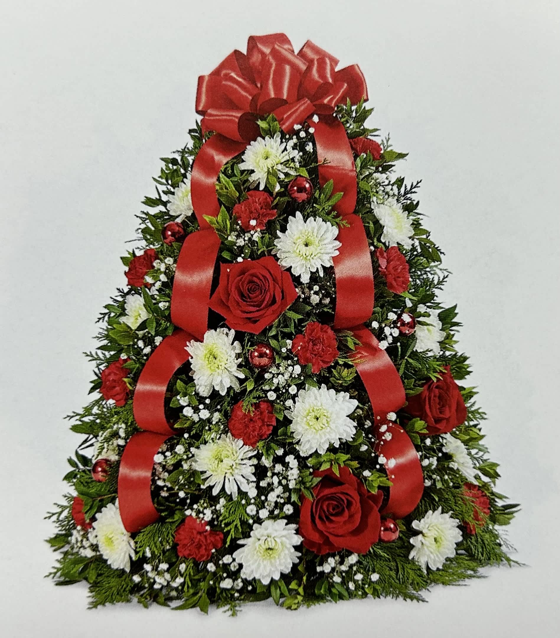 Christmas tree-shaped floral arrangement with red ribbons and red and white flowers