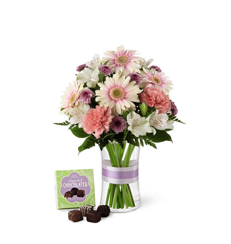 The FTD Sweeter Than Ever Bouquet - The FTD Sweeter Than Ever Bouquet is full of blushing color and fresh beauty to create a remarkable gift. Pink gerbera daisies, pink carnations, lavender chrysanthemums, bi-colored pink and white Peruvian lilies and lush greens are perfectly situated in a clear glass vase accented with a lavender satin ribbon. Arriving with a 4-piece box of chocolate, this bouquet gives your special recipient a sweet wish that will surprise and delight them with its captivating grace. GOOD bouquet includes 10 stems. Approx. 13âH x 10âW. BETTER bouquet includes 13 stems. Approx. 14âH x 11âW. BEST bouquet includes 17 stems. Approx. 15âH x 12âW.