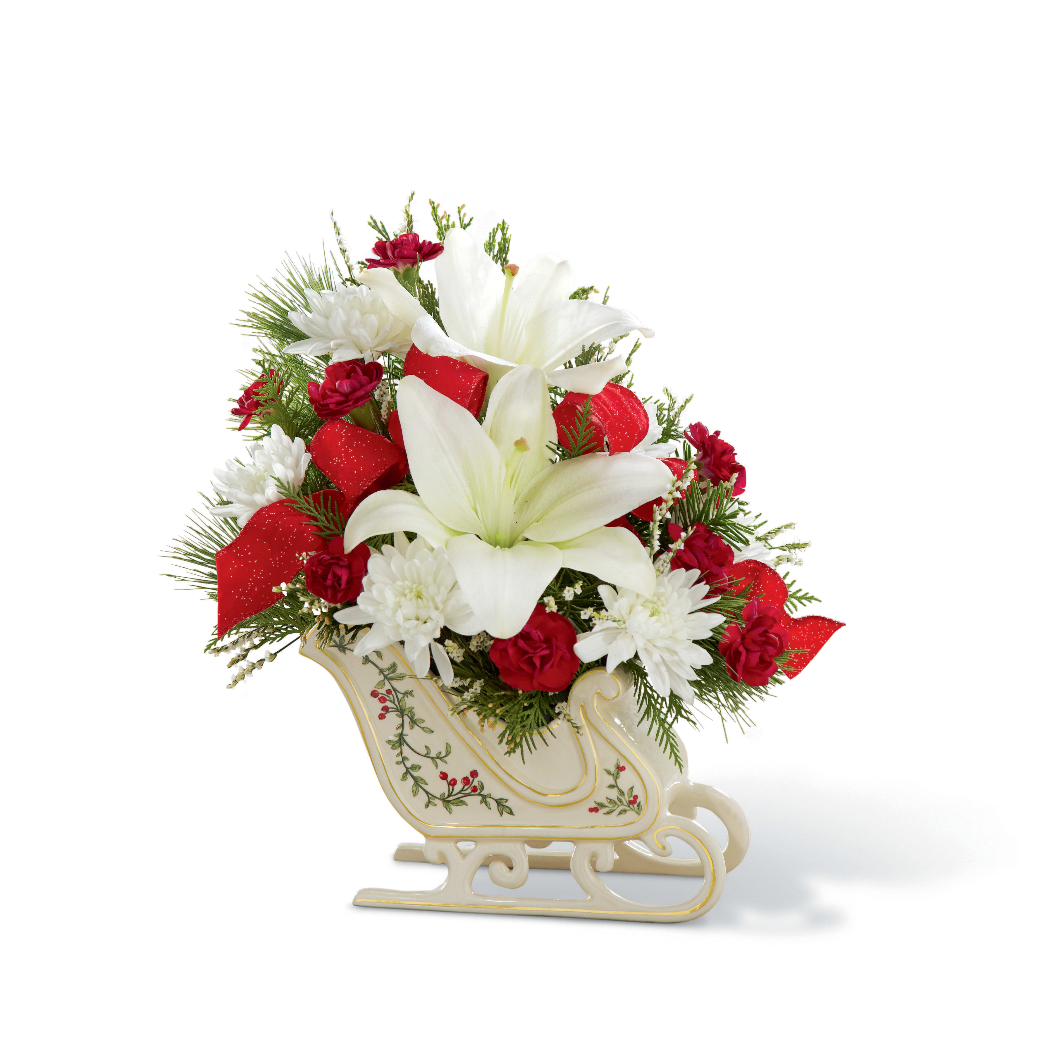 The FTD® Holiday Traditions™ Bouquet - Item Number: 15-C4s  When you want your gift to inspire a holiday full of fun, this attention-getting bouquet is a natural. This classic bouquet, newly updated for 2015, includes red roses (in Deluxe, Premium and Exquisite versions only) and carnations, snowy white Asiatic lilies and limonium with the festive addition of classic Christmas greens meticulously hand- arranged in a ceramic keepsake sleigh. It makes a dashing table centerpiece and a beautiful way to add the spirit of jingle bell joy to any space at home or at the office.