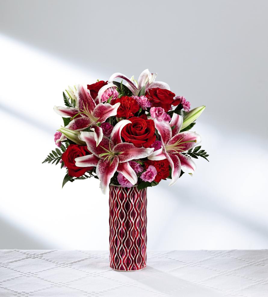 The FTD Lasting Romance Bouquet - A love that defies the bounds of time, this gorgeous Valentine flower bouquet has been designed to express your heart's every emotion. Rich red roses and exquisite Stargazer Lilies are truly fascinating surrounded by red carnations, pink mini carnations and lush greens. Presented in a keepsake mosaic red and pink glass vase with a modern pattern, this romantic flower bouquet is set to make you special someone's heart beat a little faster this February 14th. GOOD bouquet includes 8 stems. Approx. 16"H x 12"W. BETTER bouquet includes 11 stems. Approx. 17"H x 13"W. BEST bouquet includes 14 stems. Approx. 18"H x 14"W. EXQUISITE bouquet includes 20 stems. Approx. 19"H x 15"W.