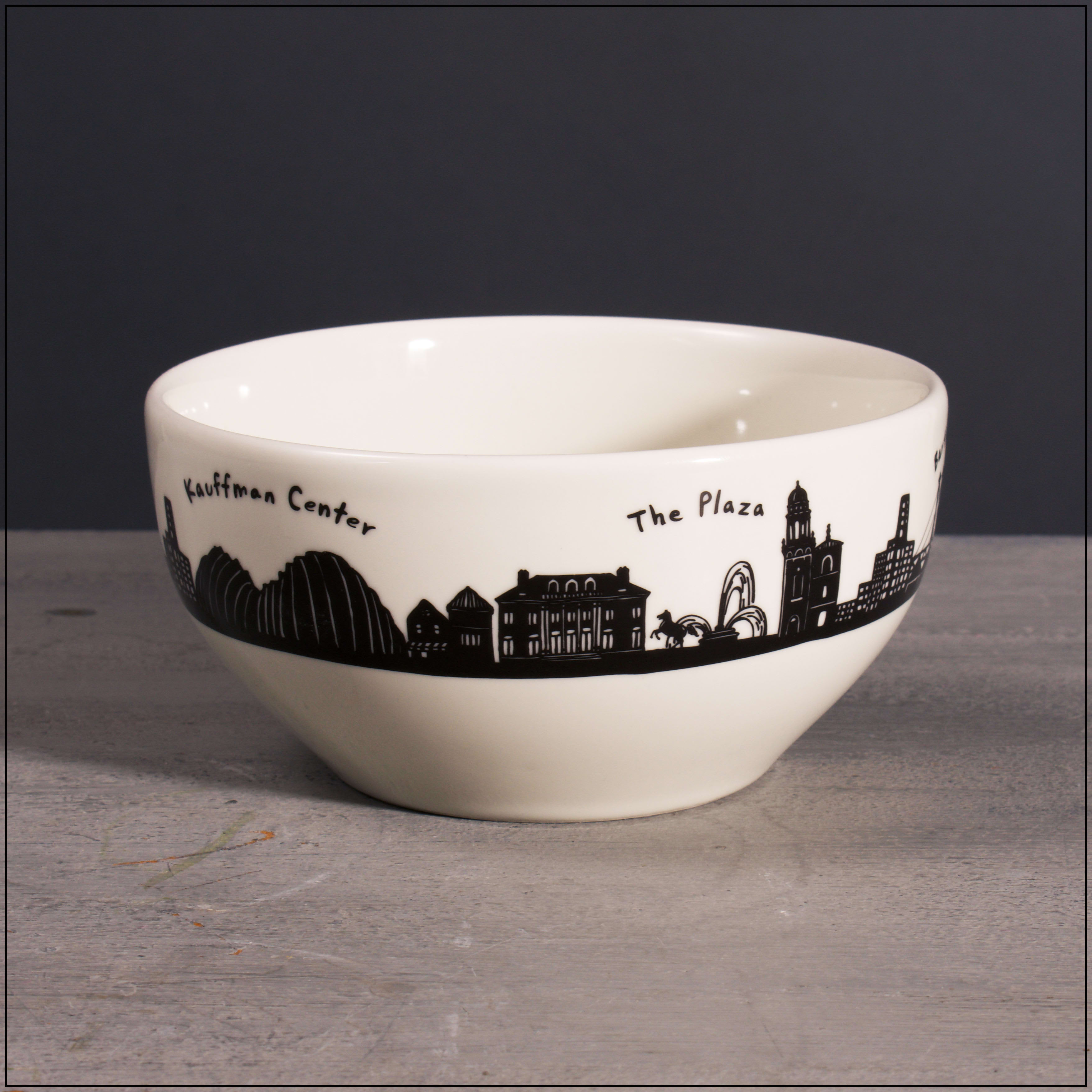White ceramic bowl with a black city skyline and landmark names around the rim.