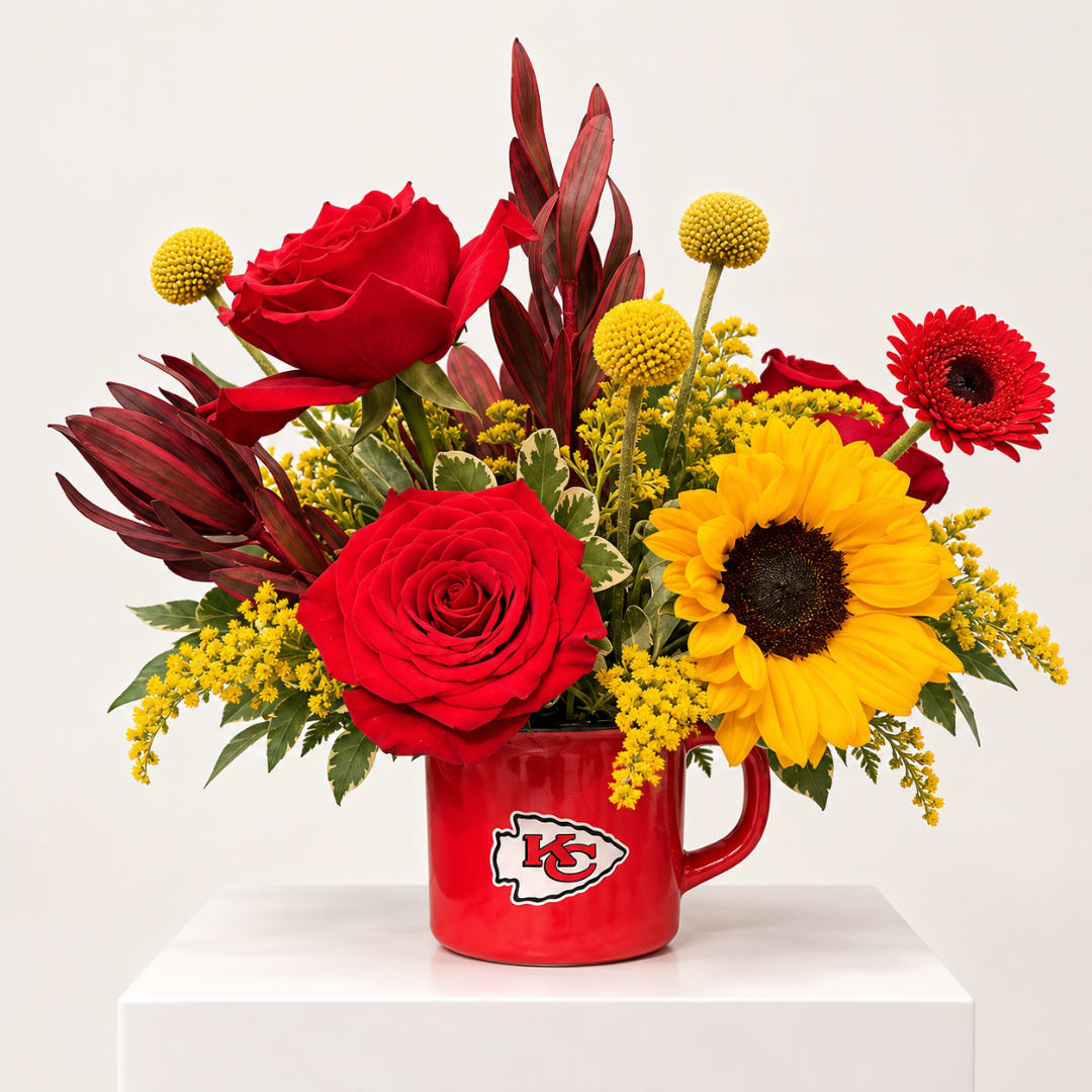 Red roses and a sunflower in a red mug with a KC logo