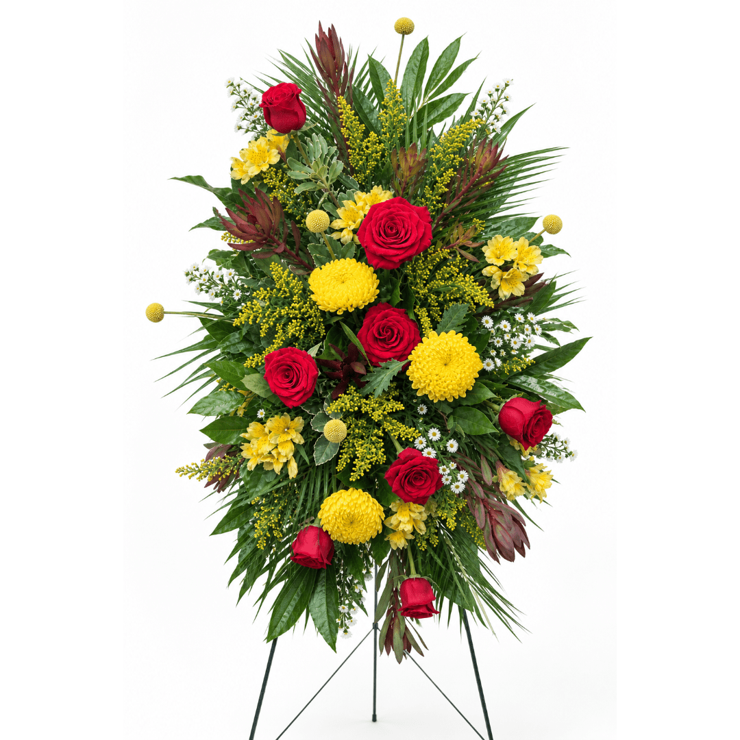 Tall standing floral spray with red roses and yellow blooms on a tripod easel