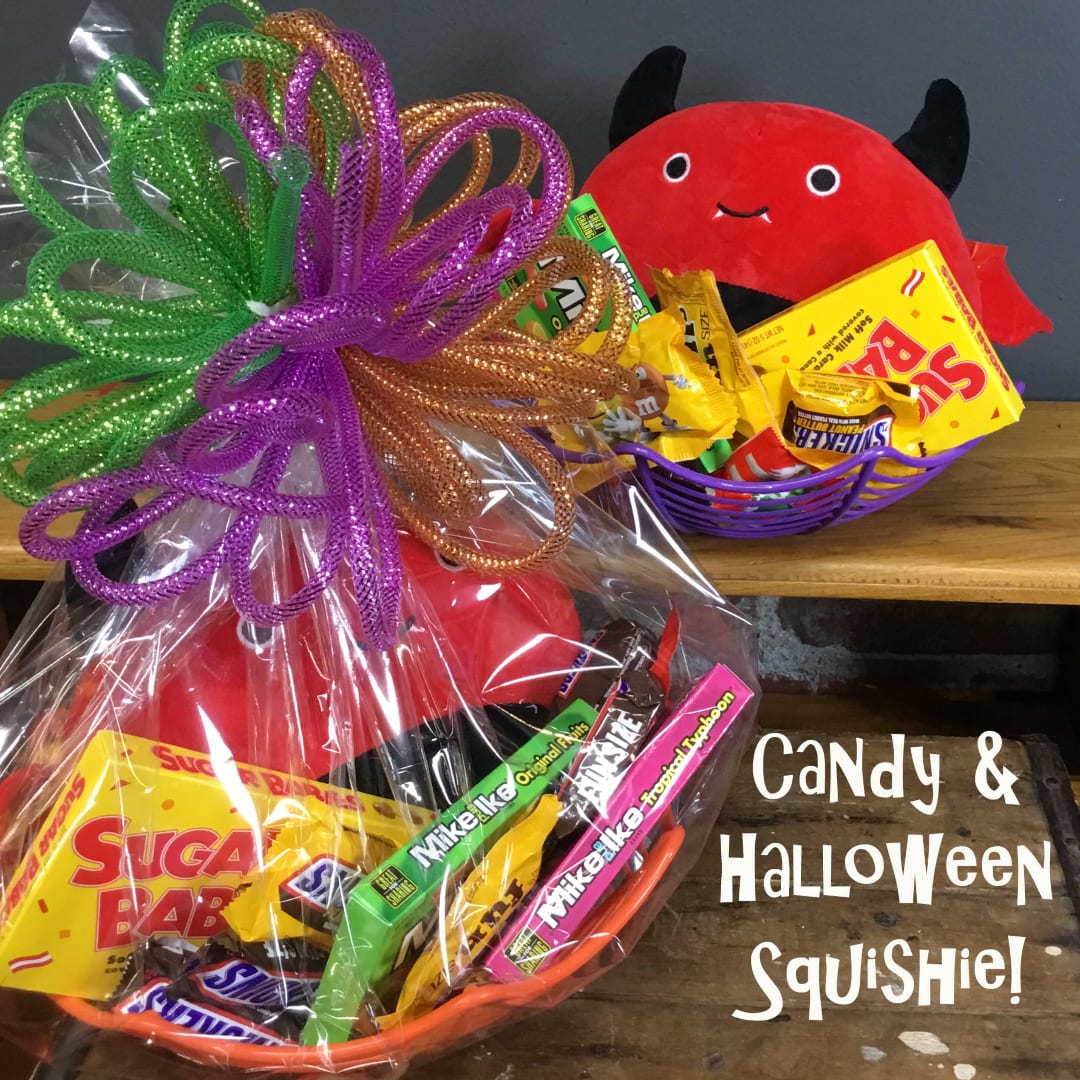 Halloween candy baskets with a red devil plush and colorful ribbon bows