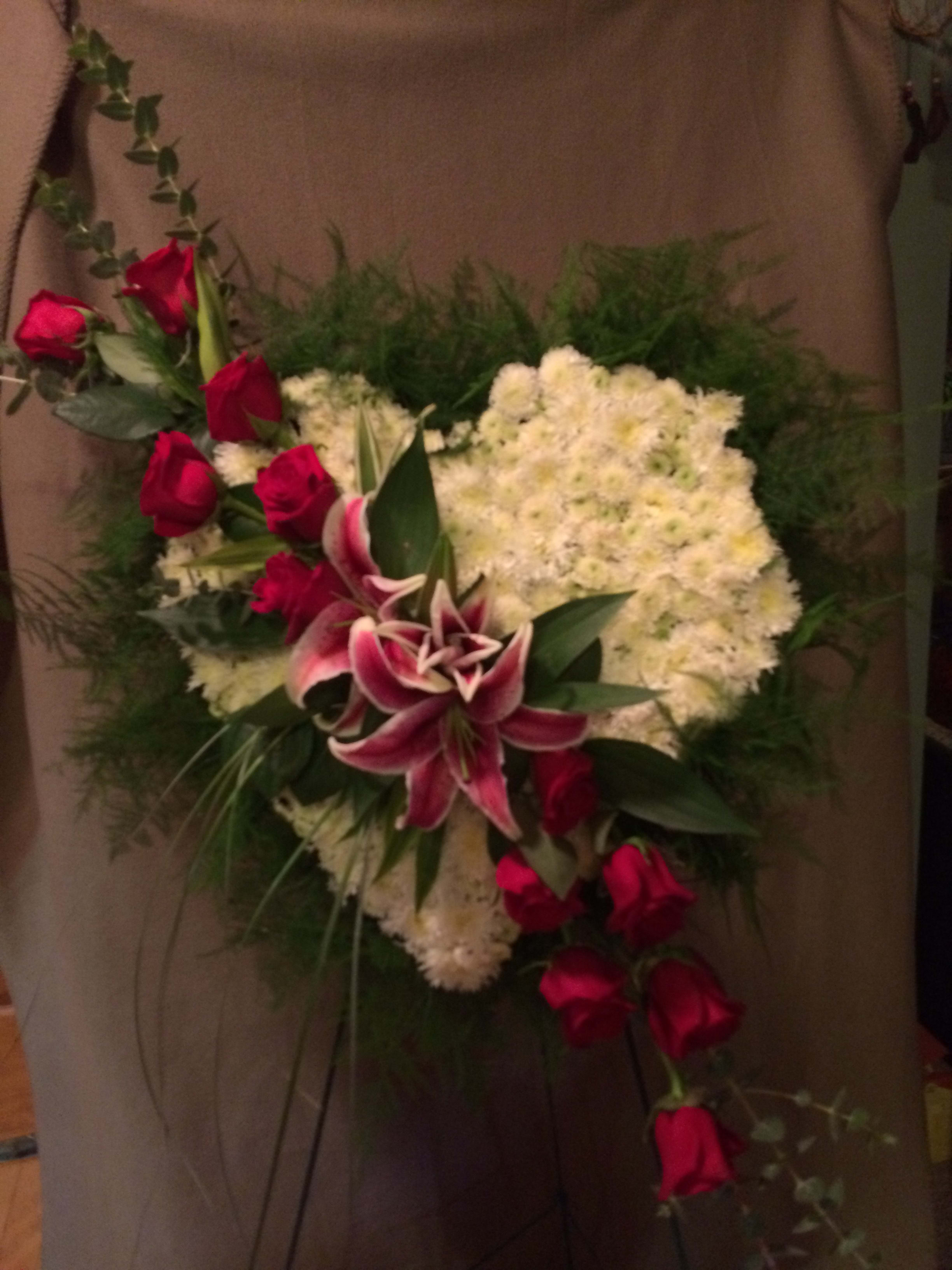 Heart-shaped floral arrangement with red roses and white chrysanthemums