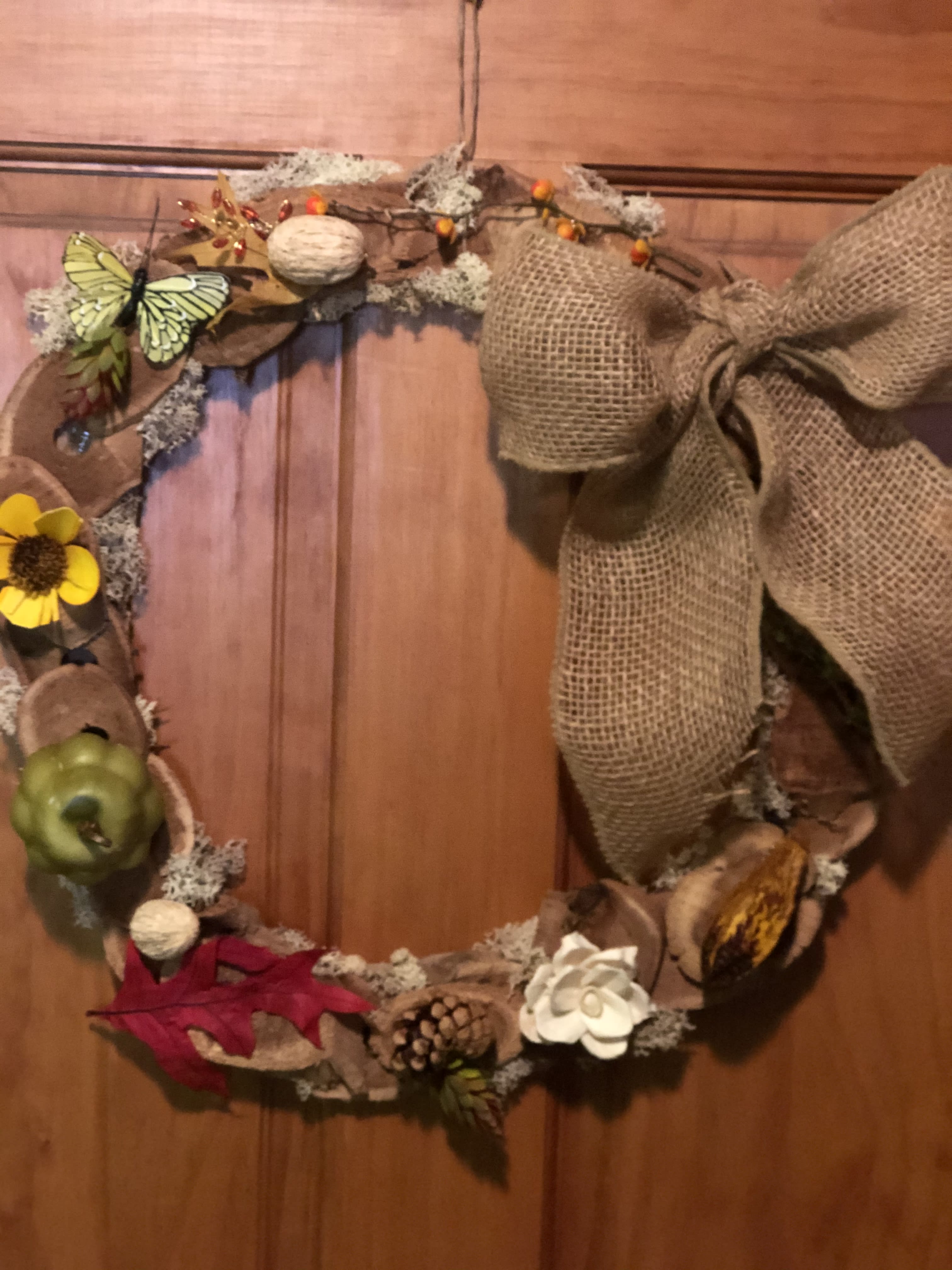 Wooden Wreath  - A handmade wooden wreath, made of wood slices with burlap bow &amp; dried accents. Preferably, hang on a inside door or wall. Dried accents will not stand up to outdoor conditions. One-of-a-kind design. Wire hanger included. #Wood #Moss #handmade #burlapbow Approximately 14" round.