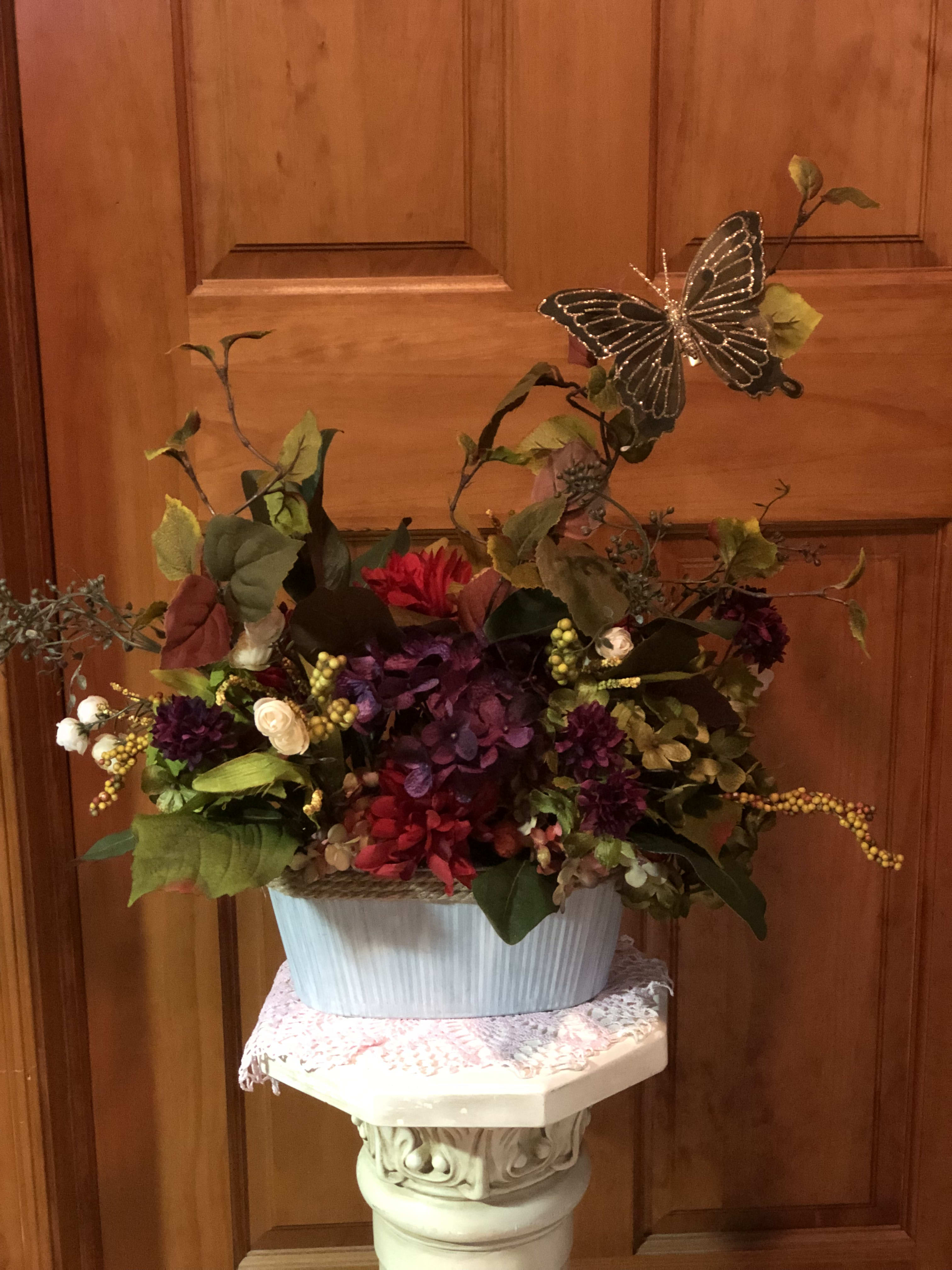 Faux Autumn Arrangement - Stunning shades of the season come together in our Faux Mixed Fall Hydrangea arrangement. Display this charming bouquet on a mantel or console, or use it as a centerpiece on a dining table. Made of polyester, plastic, tin and wire. For indoor use. Size of container is 9" X 4 1/2"  Arrangement Approximately 16" wide by 18" tall.