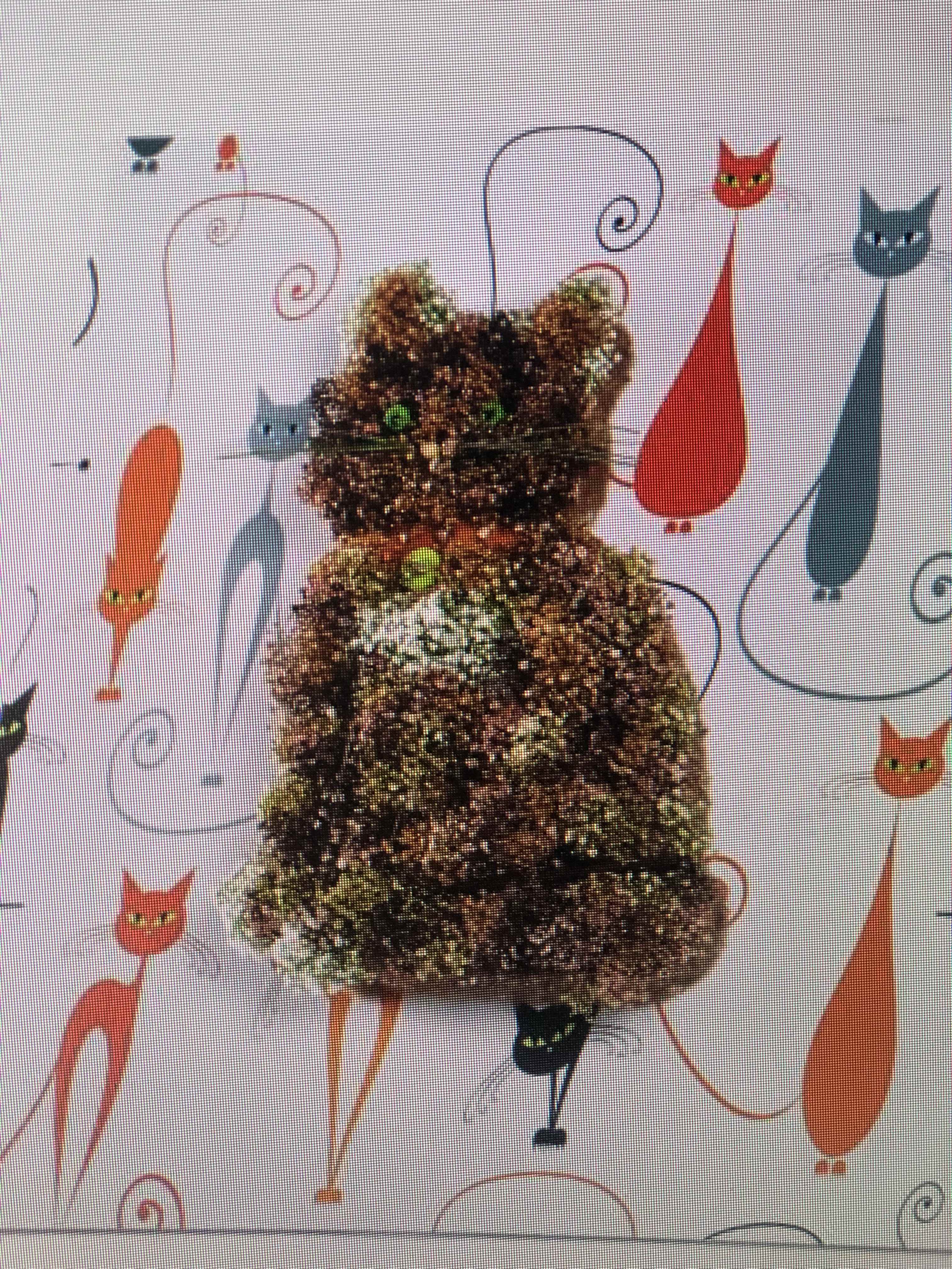 Cat-shaped glitter decoration with green eyes on a patterned background