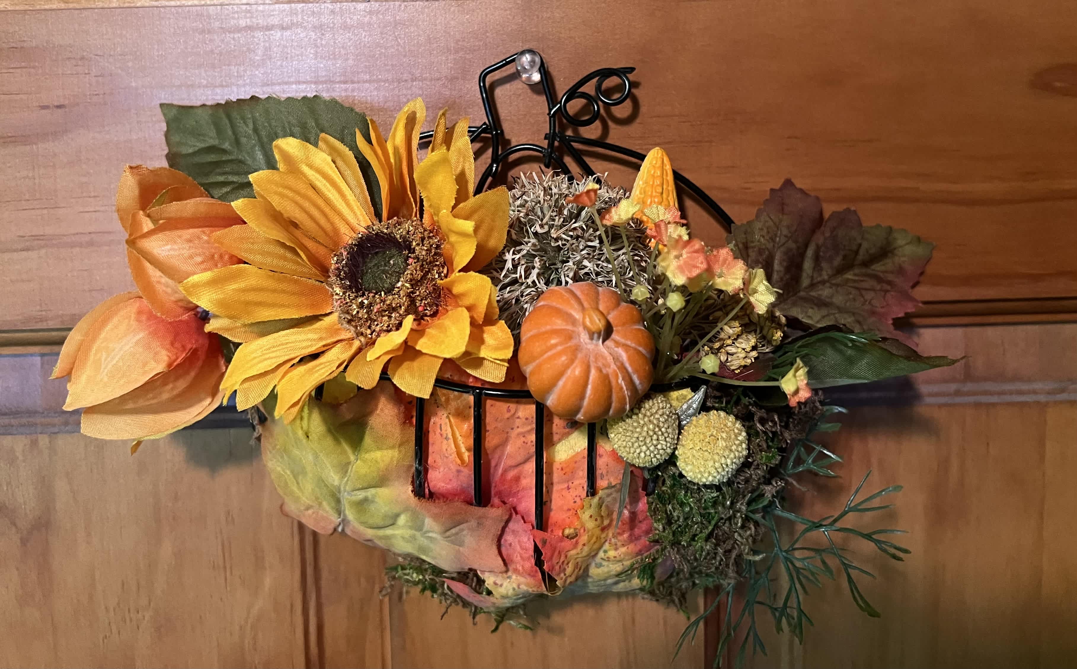 Wall Decor - Fall wall decor in the shape of a pumpkin filled with silk flowers for every year display. Hand created with you in mind, unique and different to fit the season. Can be hung on the wall or front door to welcome the season. overall size: 6" X 6" Great as an add on to any other floral design. 