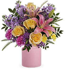 Pink lilies and yellow roses in a pink vase