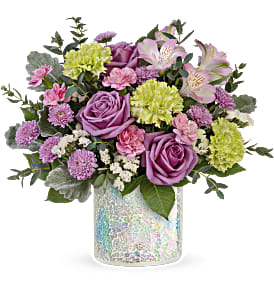 Pink and lavender bouquet in a iridescent glass vase