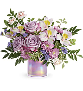 Lavender roses and lilies in an iridescent vase