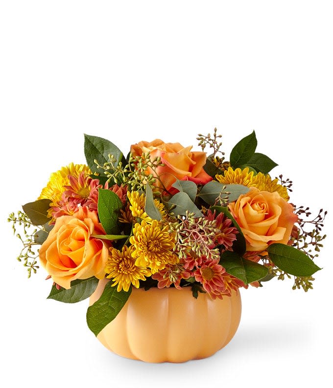 Pumpkin Spice - Cute ceramic pumpkin filled the fall tones of roses and mums complimented by greenery