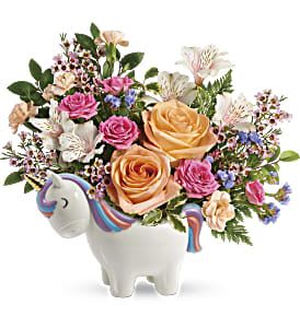 Bouquet of roses and mixed flowers in a unicorn-shaped vase
