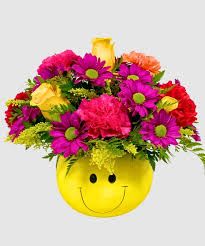 Have a nice day! - Roses, mums, carnations, alstro, all in bright colors and in a keepsake ceramic smiley face bowl!
