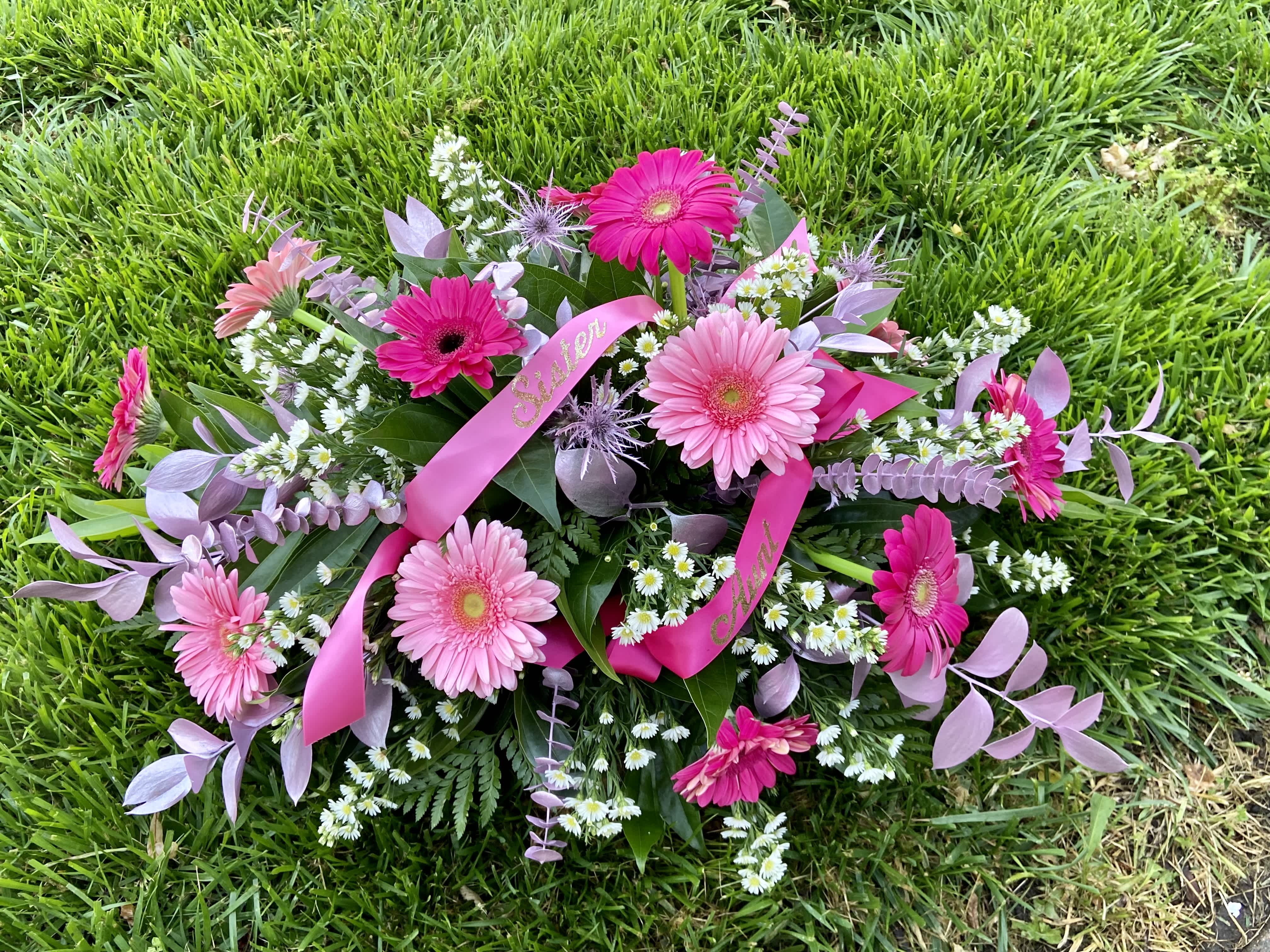 Pink Tribute Spray - With a bounty of lovely pink flowers and simple greens, this pretty spray lets you express your sympathy beautifully. 