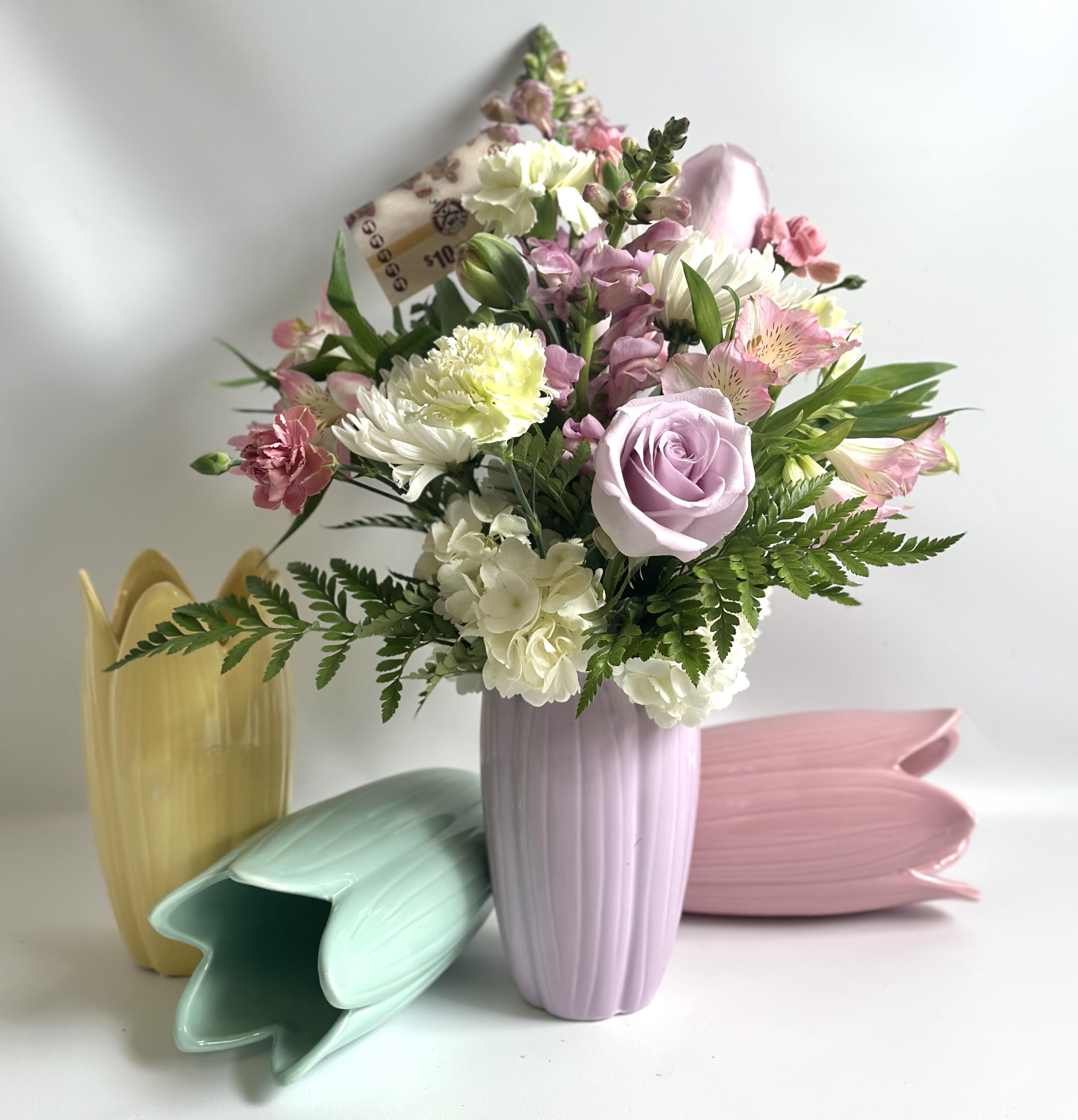 Mother’s Day Bloom &amp; Brew Bundle by Barb’s Flowers - This beautiful ceramic Tulip vase is filled with roses, hydrangea, tulips, carnations, snapdragons, alstroemeria and so much more. And is bundled together  with a $10 dollar gift certificate to our local coffee shop called,  “My Coffee”.  Great gift for Mom. 