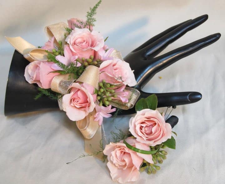 Beautiful and Blushing Corsage Set - A wrist corsage of light pink spray roses, light pink hyacinth accented with a champagne ribbon and greenery on a standard wristlet, with a matching boutonniere. Substitutions may be made if needed. 