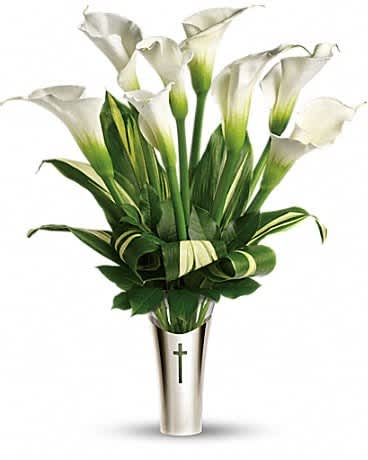 Teleflora's Inspiration Bouquet - The fragrant white calla lilies are breathtaking. The stunning contemporary vase with its cross motif will be a treasured keepsake. A lovely choice for home or service. The gorgeous bouquet includes six large white calla lilies, accented with ti leaves and salal. Delivered in glass vase inside a silver-toned sleeve adorned with a cut-out cross.