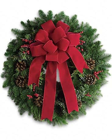 Classic Holiday Wreath - The holidays are knocking at the door. Luckily, here's a gift that always gets a warm welcome! It's a classic holiday wreath with some very lovely extras. A beautiful noble fir wreath with juniper branches, pinecones and berry sprays is adorned with a brilliantly festive red velvet bow. Anyone would be delighted to have this arrive on their doorstep!