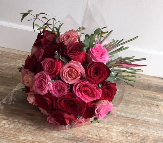 Love Me Do  - 3 dozen mixed colored roses hand tied with ribbon. Colors based on availability. Vase not included - recipient must be home. For specific color preferences at least 2 day advance notice needed.