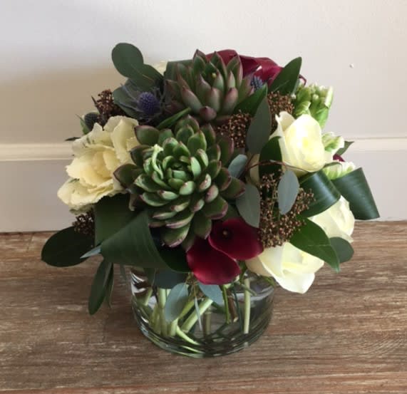 Blackbird  - An organic mix of seasonal greens, succulents, roses and other seasonal flowers.  Great for people who love earth tones and a modern feel.