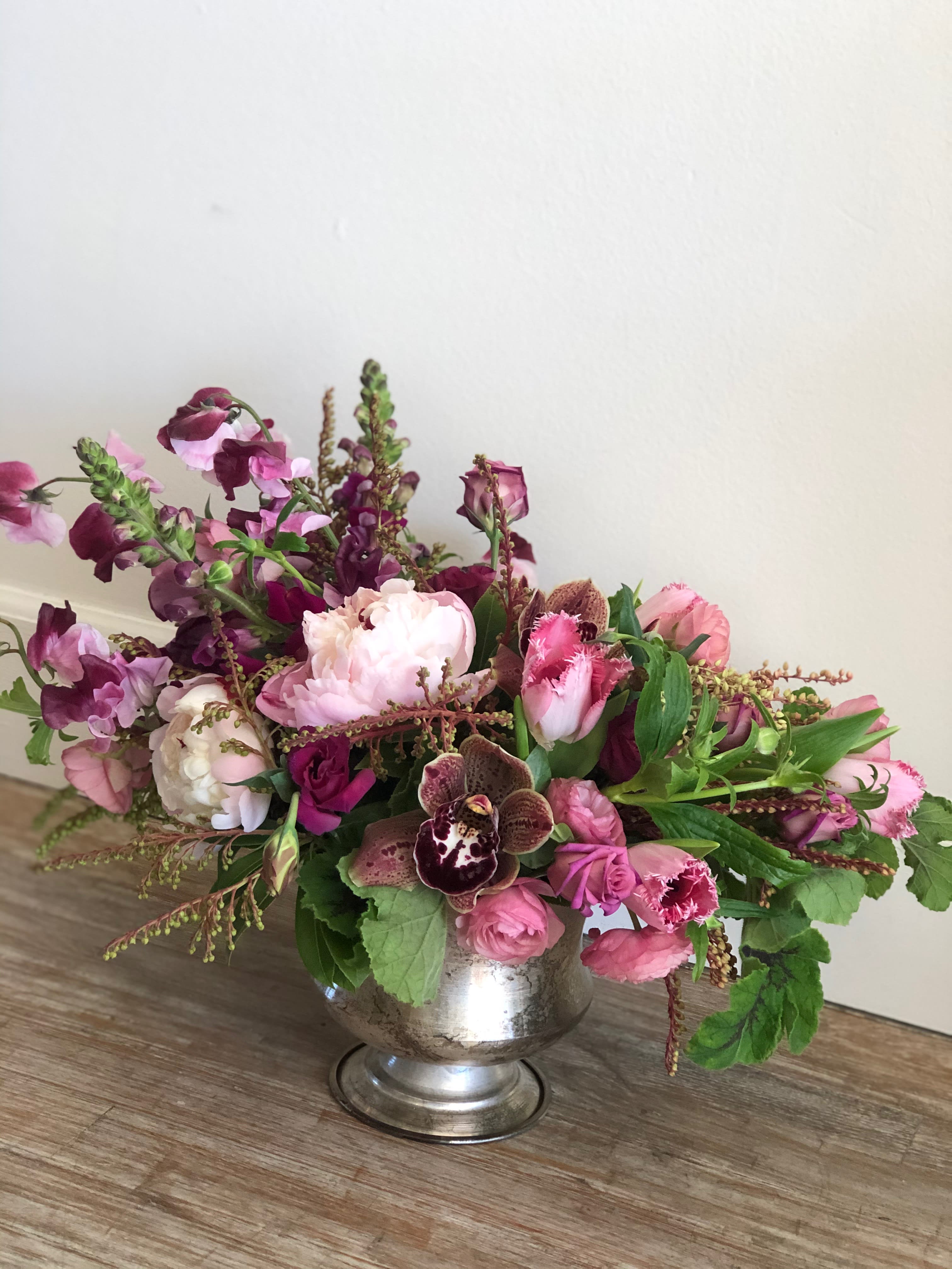 Raspberry Beret - A beautiful still life style arrangement in raspberry and pink tones. Some flowers may be substituted based on season and availability. Vase may also be substituted upon availability. 