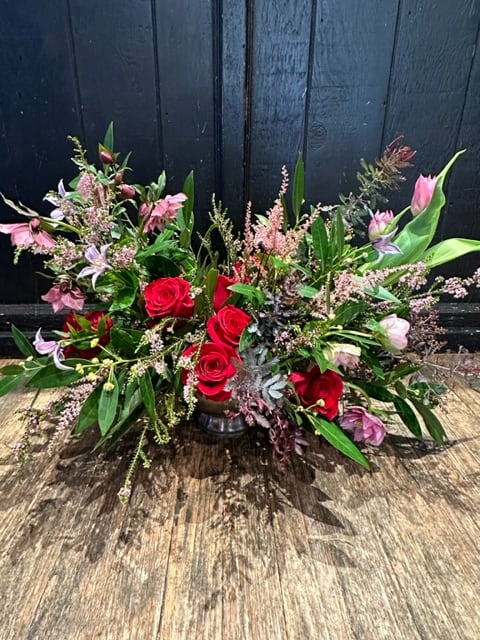 Angel Dream - A Romantic mix of seasonal blooms in shades of red lavenders and pinks in an urn.