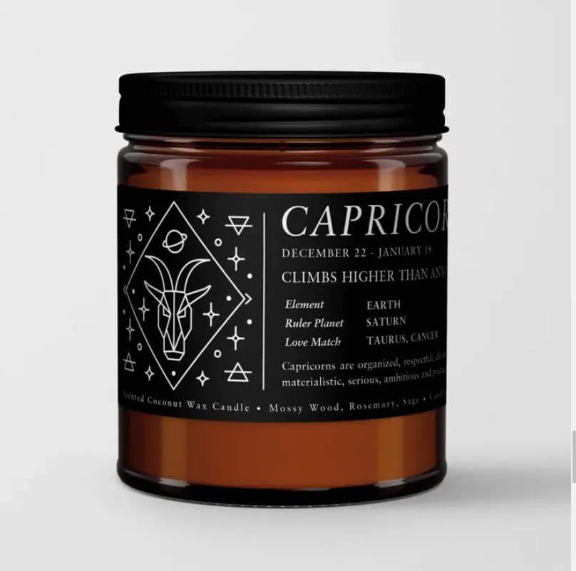 Amber candle in a black-lidded jar with a Capricorn label