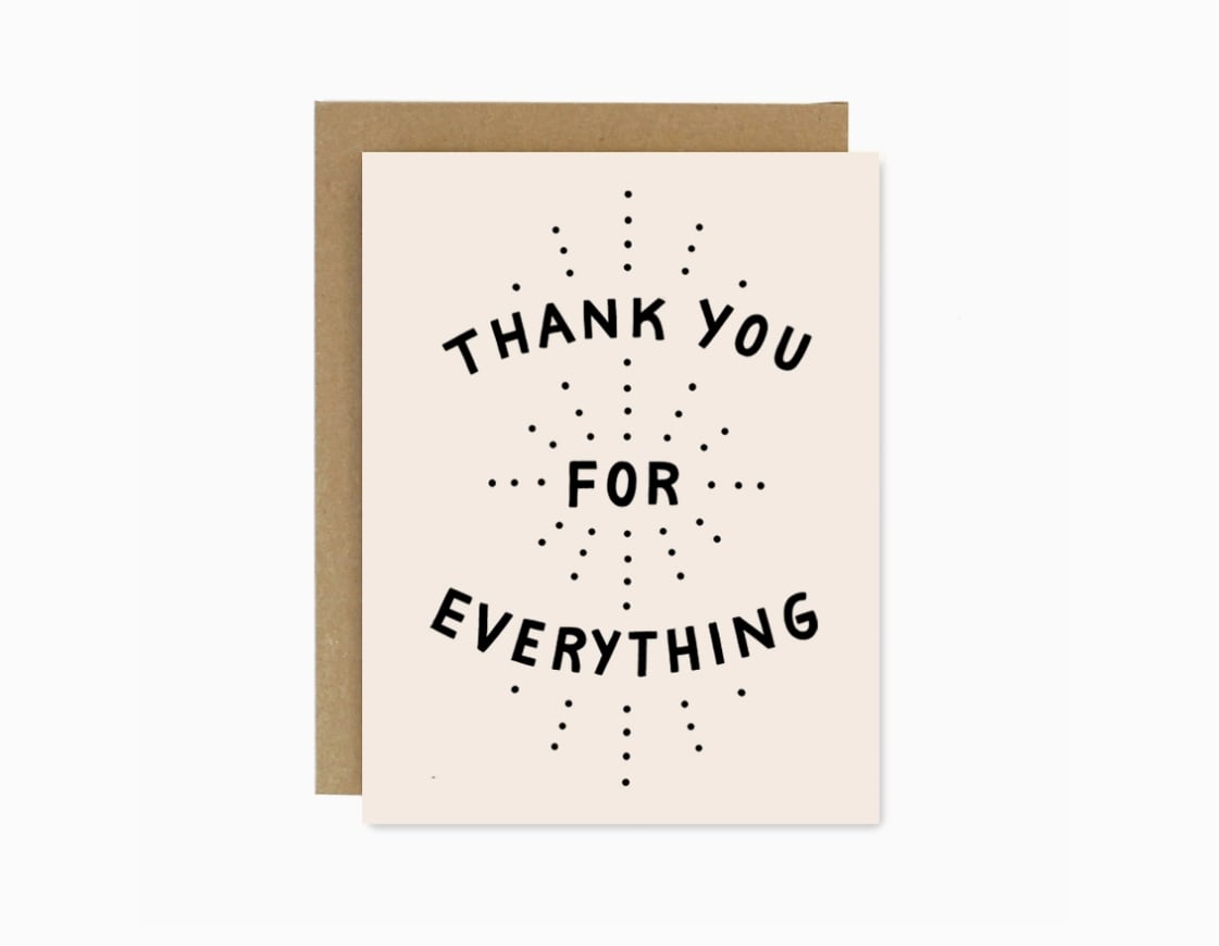 Thank you greeting card with black text on a cream front and brown envelope