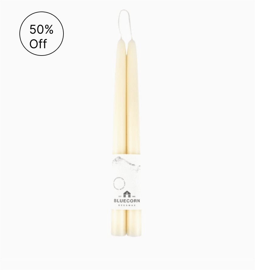 Pair of cream taper candles wrapped together with a Bluecorn Beeswax label