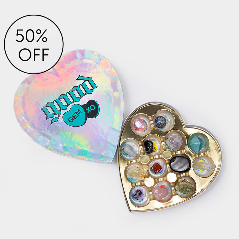 Heart-shaped gem assortment in a gold tray with an iridescent lid