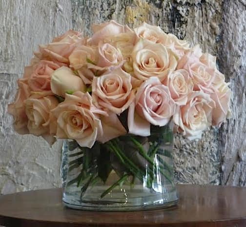 Bouquet of pale pink roses in a clear glass vase