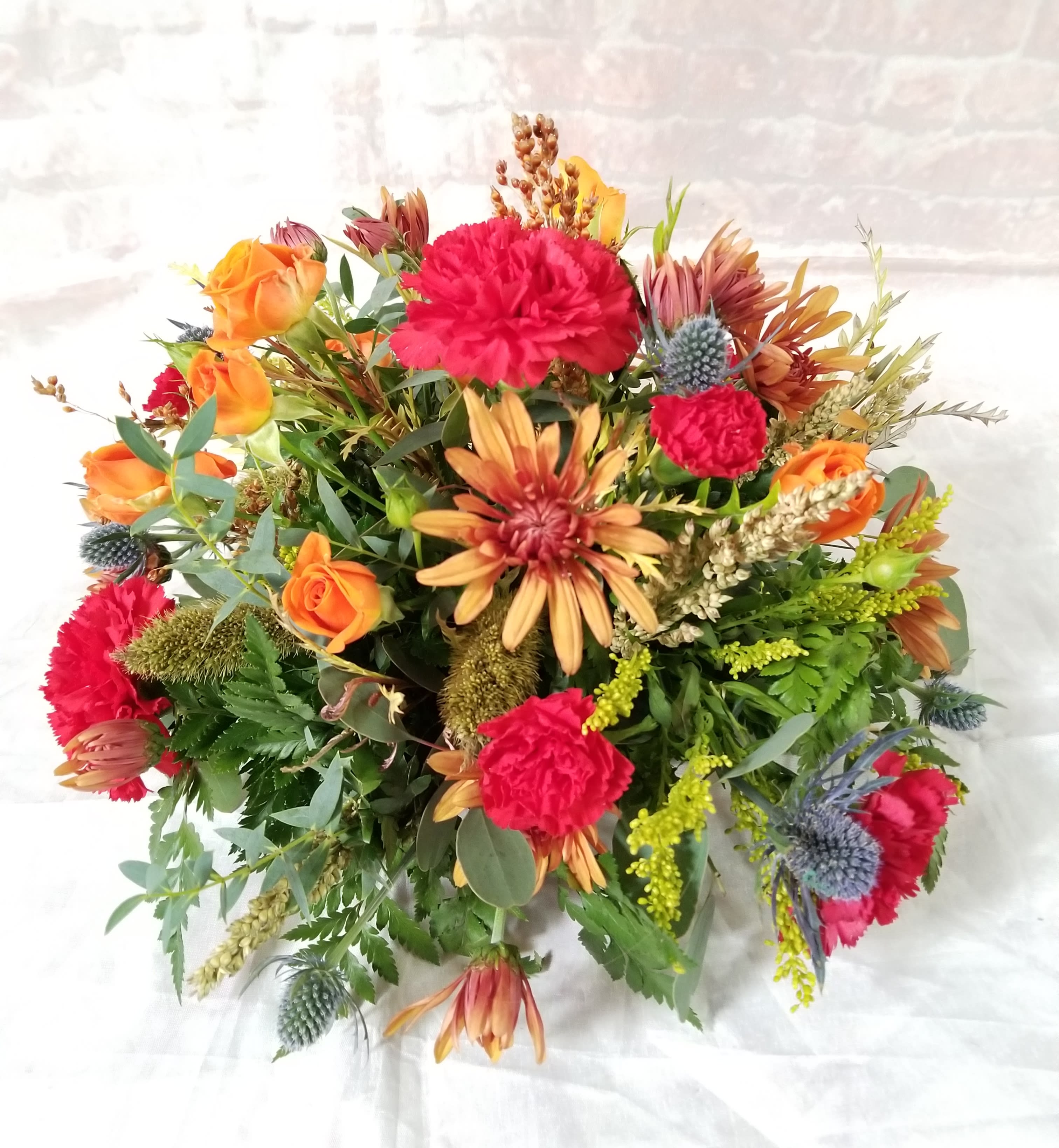 Autumn Moon  - Select this rounded centerpieces of carnations, spray roses and chrysathemums that is perfect for your Thanksgiving table! 