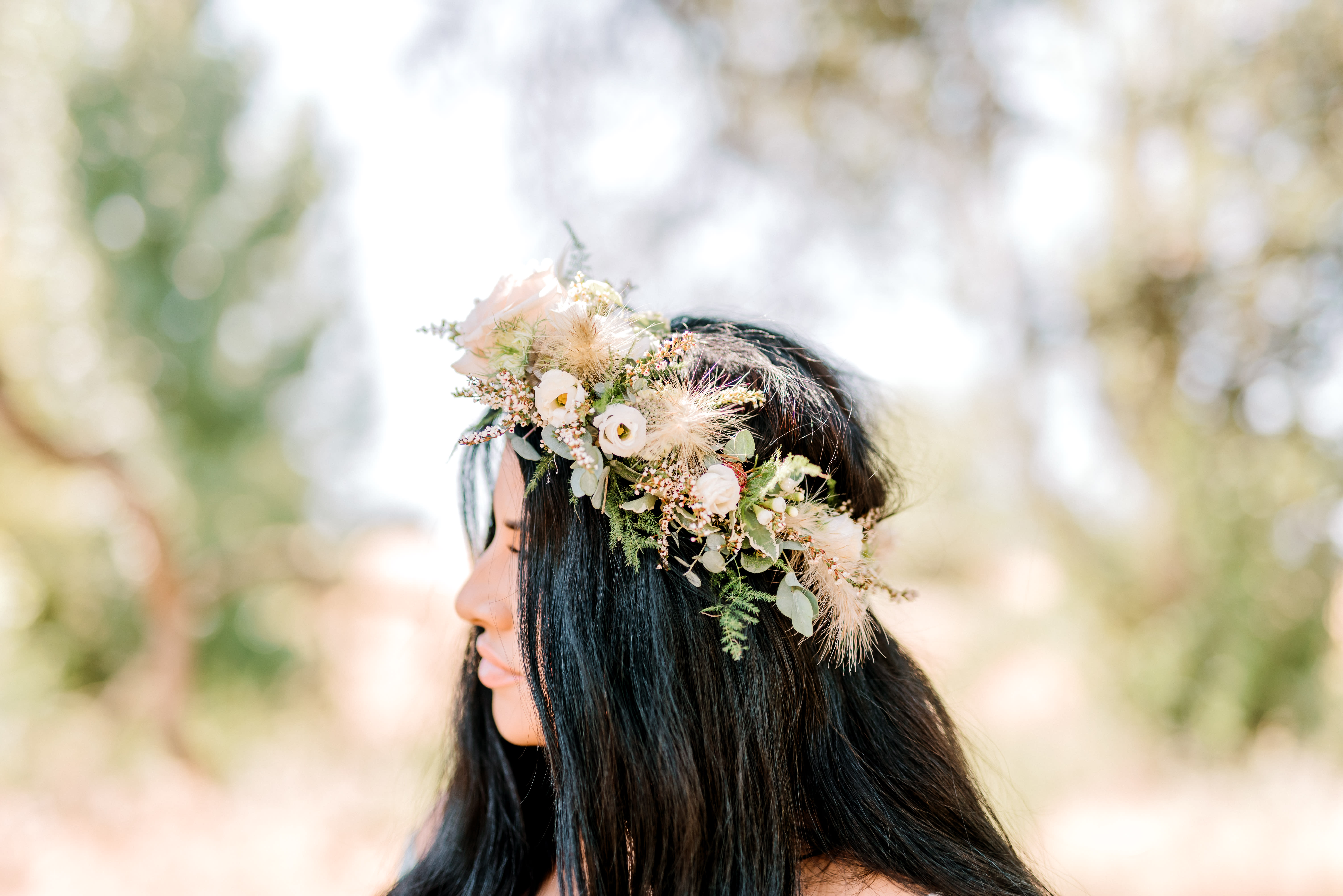 Woman wearing a floral crown with white and blush flowers