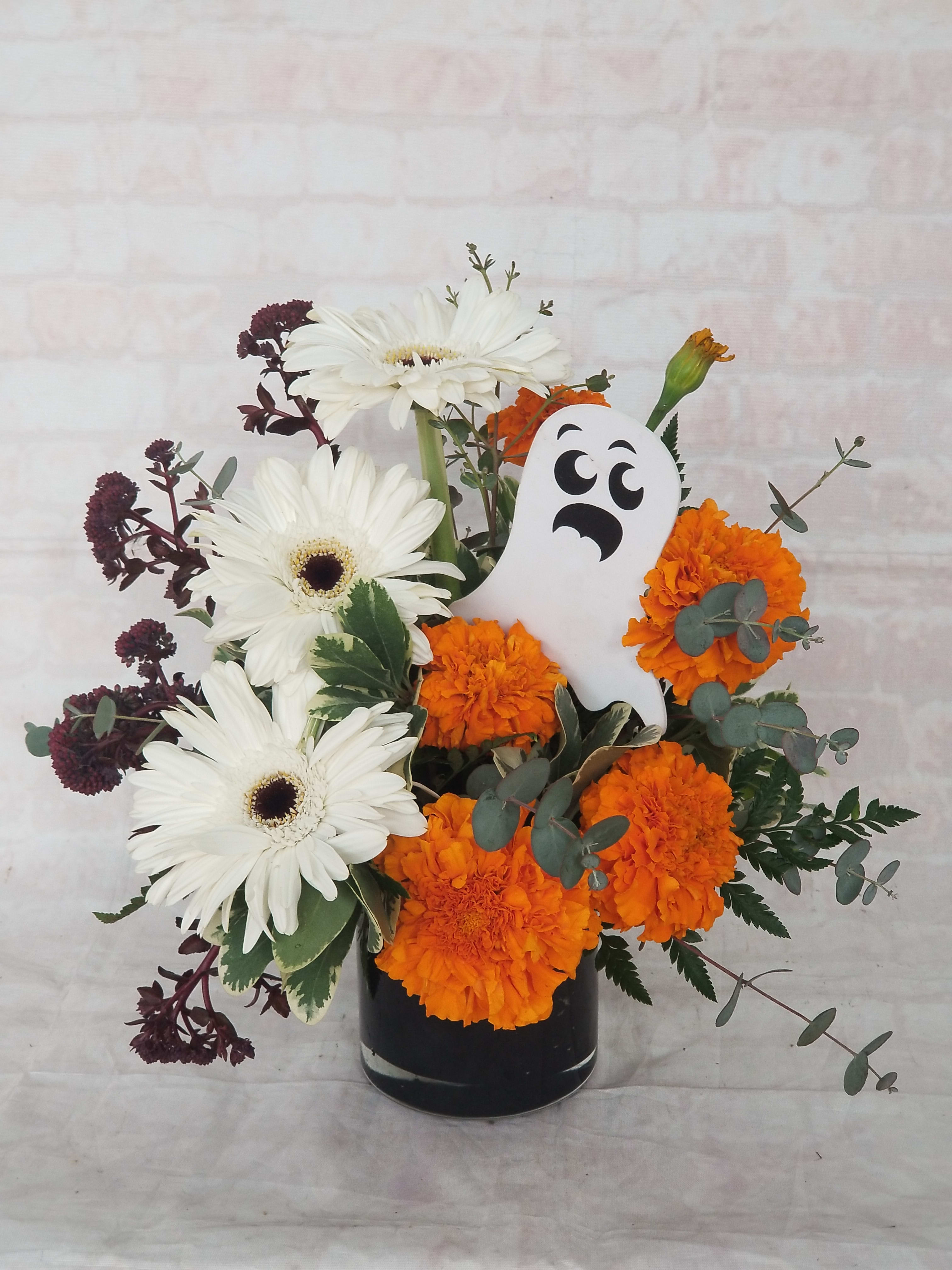 Ghoulish Garden - Boo! This Halloween arrangement includes gerbera daisies and marigolds. 