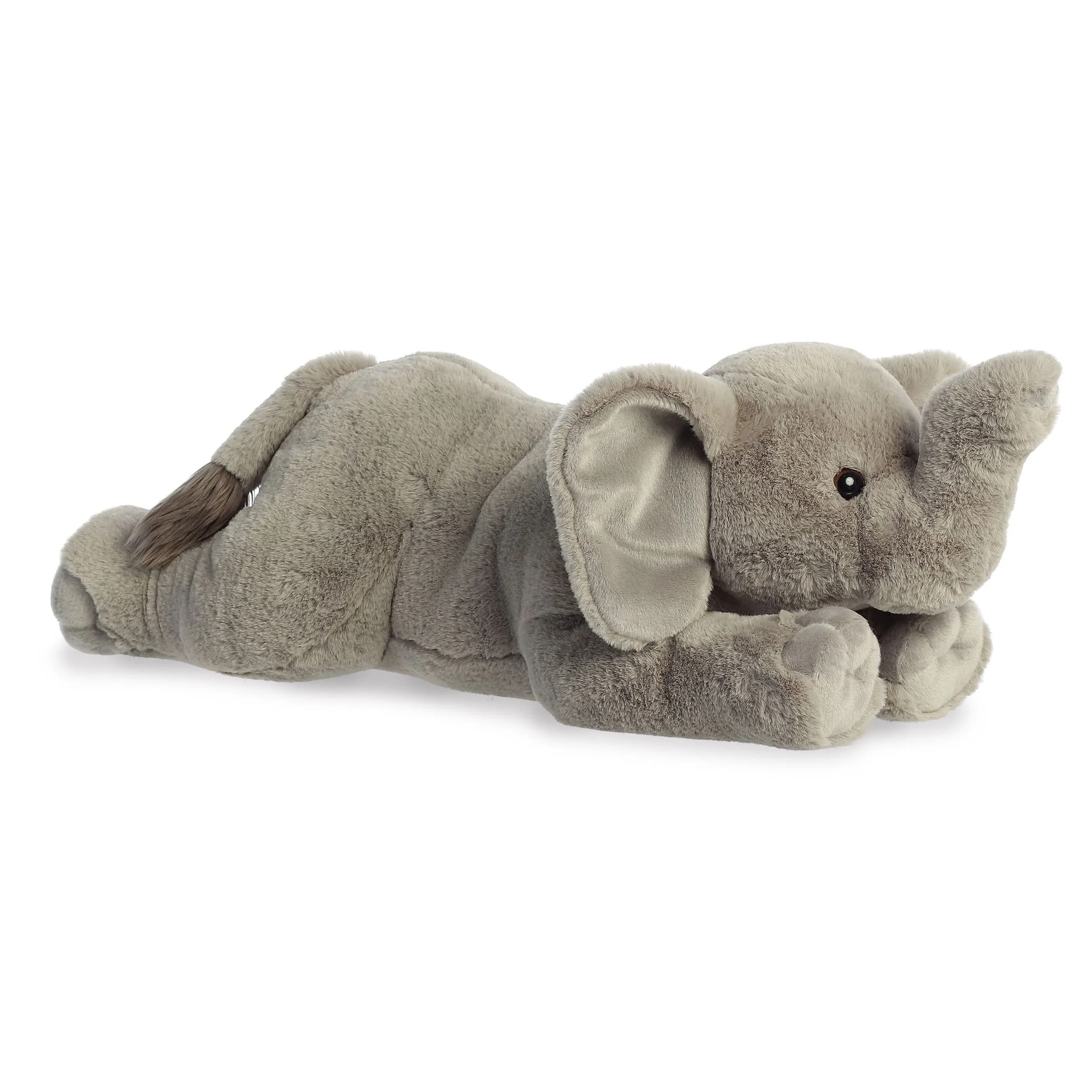 Plush gray elephant toy lying on a white background