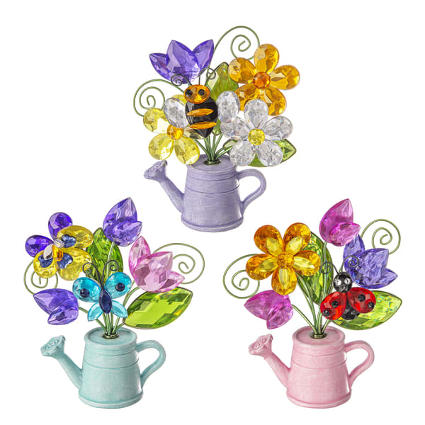 Garden Watering Can Figurine  - These colorful garden watering can figurines feature crystal-style flowers and cute gardens bugs like bees and ladybugs. These whimsical decorations add a cheerful, springtime touch to any home or garden display.  *Only one figurine is included per order. and the color will be chosen by our staff unless a preference is noted at checkout.*  4 1/2" H.