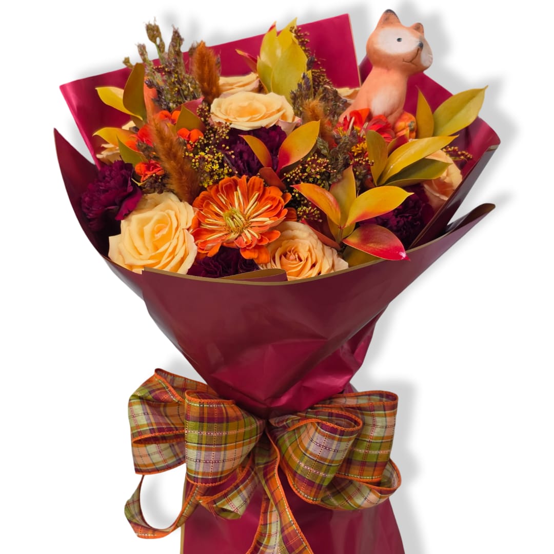 Bouquet of orange and cream flowers with a small fox figurine