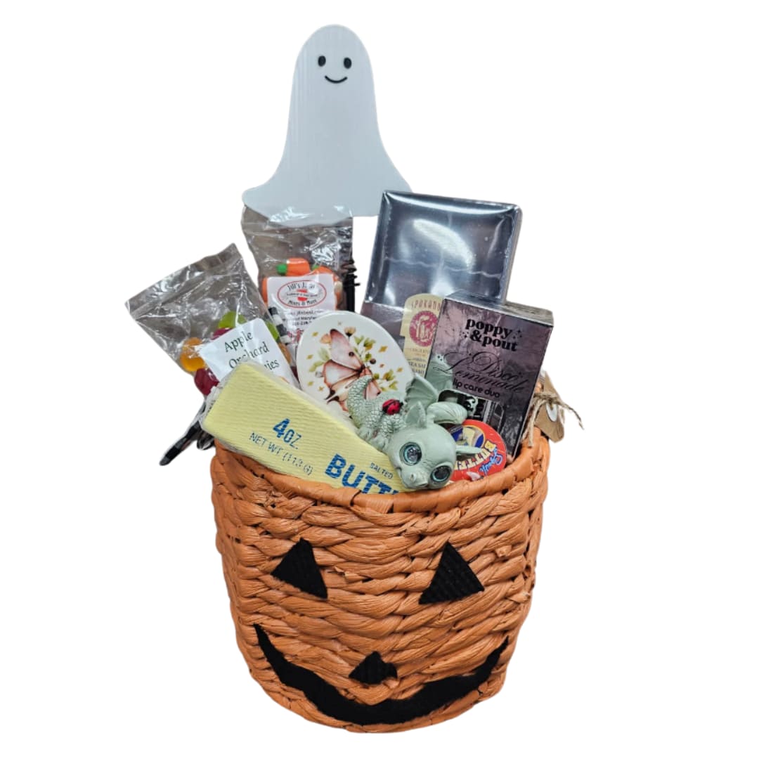 Halloween gift basket in a jack-o'-lantern basket with candy and a ghost topper