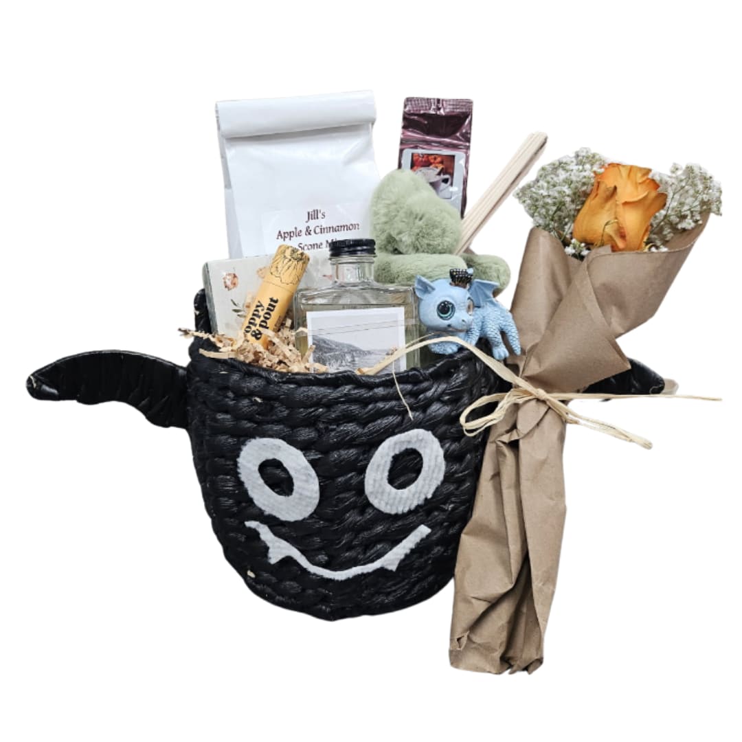 Gift basket with a small bouquet of orange roses and packaged treats