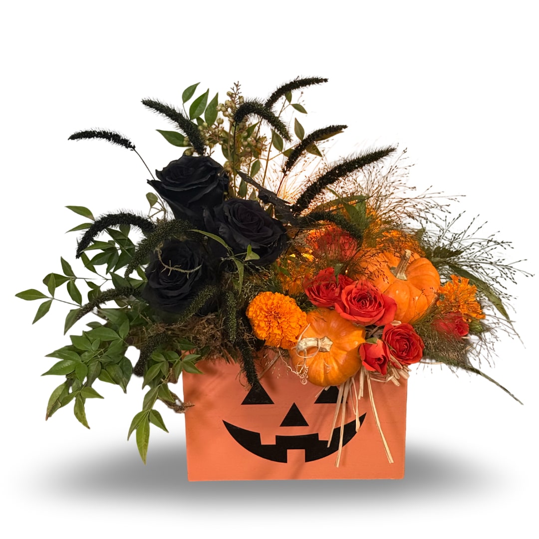 Halloween floral arrangement in a jack-o'-lantern box with roses and pumpkins