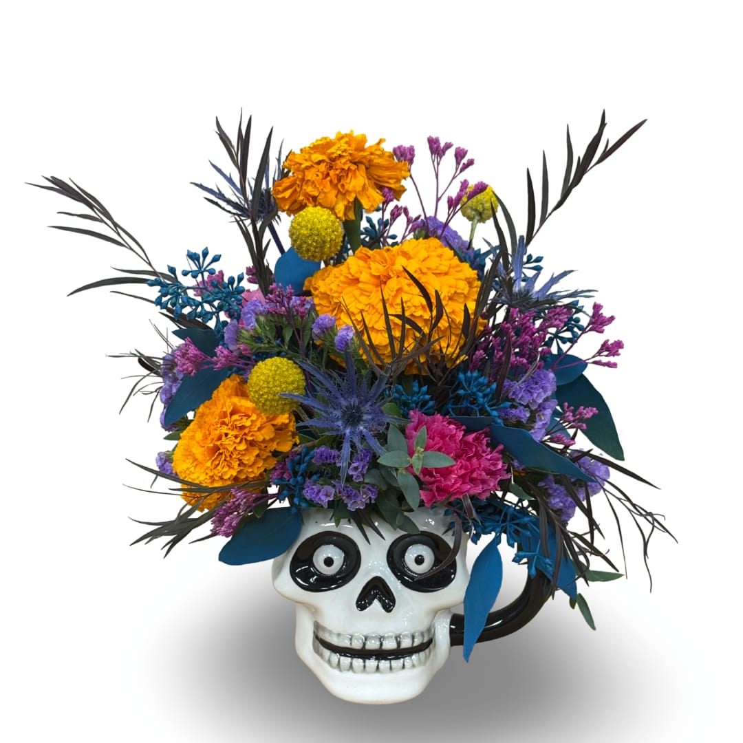 Colorful floral arrangement in a skull-shaped mug with bright marigolds