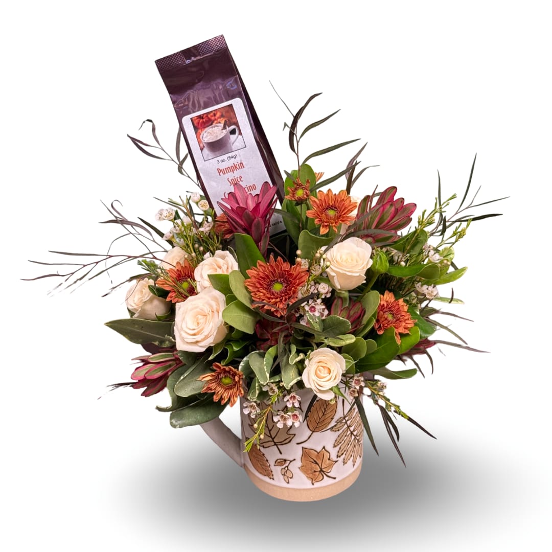 Fall bouquet in a leaf-print mug with roses and orange mums