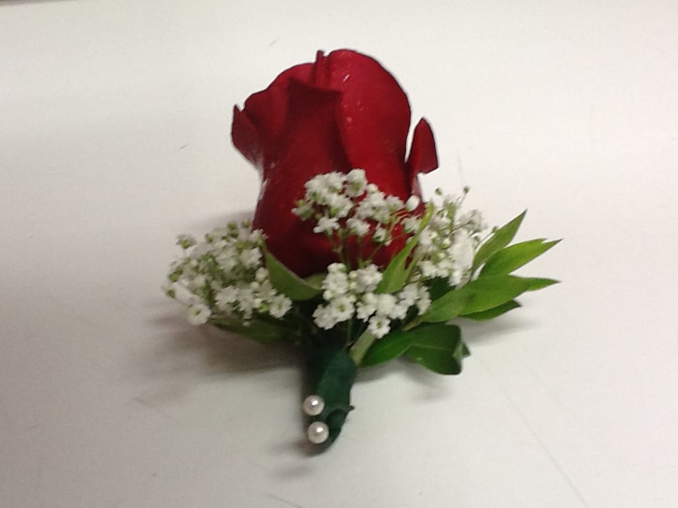 Boutonniere - Consist of 1 rose, Baby's Breath , and Foliage  Rose is available in red or white   *Order must be placed 2 - 3 days in advance* (Please note, same day pick-up or delivery is not available for this product)
