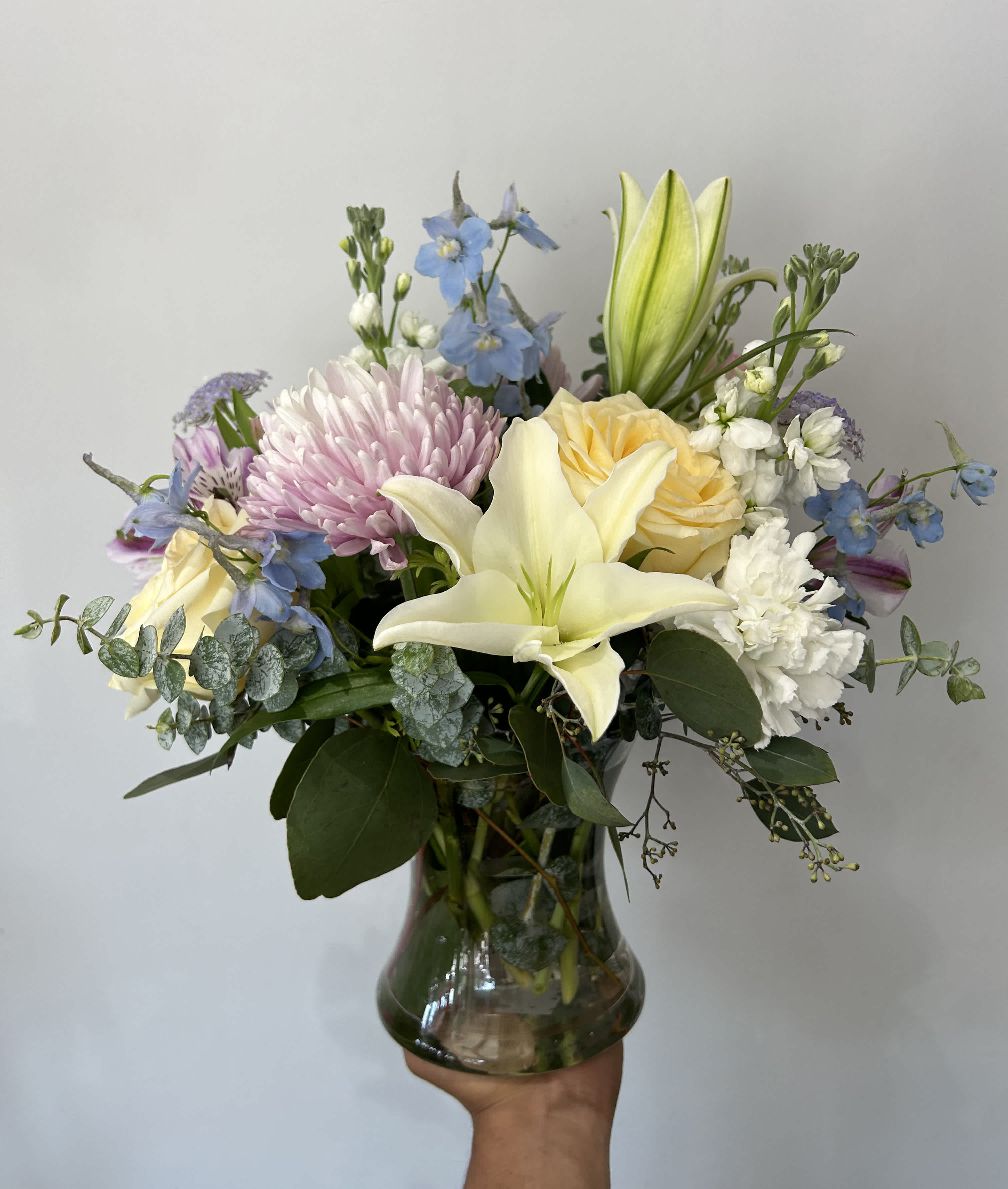 Soft Touch - Seasonal white and pastel flowers arranged with greens into a vase. 