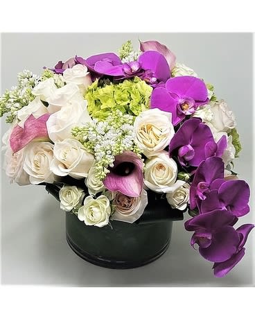 Colleen  - beautiful high end floral vibrant colors toped with a full stem of orchids  roses, callas, orchids, hydrangea 