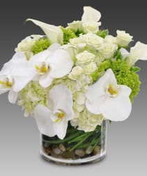 Whisper - Classic floral with a modern vibe,  exotic orchids nestled in a bed of roses and emerald green hydrangea 