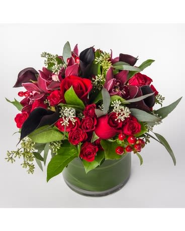 Lady Lux - stunning holiday mix of premium florals  orchids, calla lilly, roses, rustic berries, holiday greens  arranged in a modern vessel,    cylinder, or cube vase available 